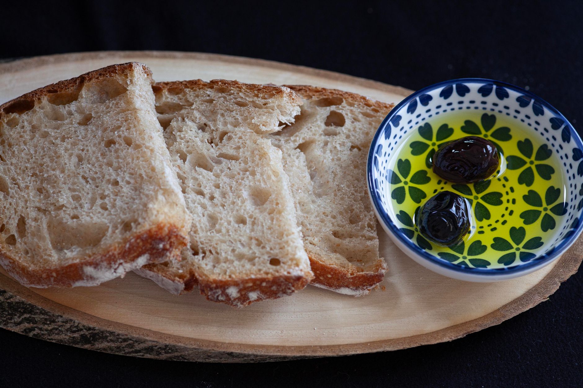Fresh Mediterranean harvest feast with olive oil, herbs, and bread